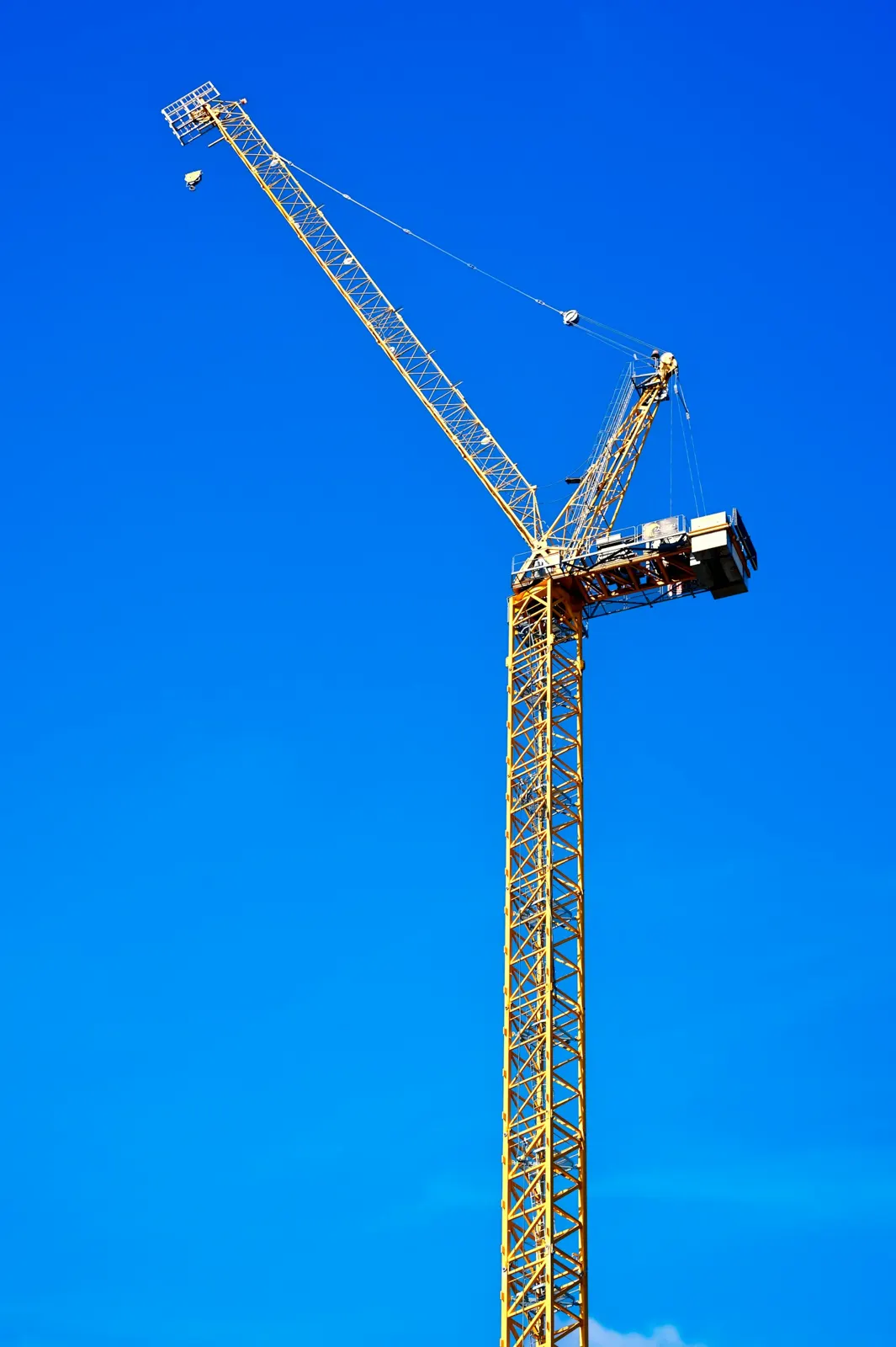 Tower crane against a blue sky